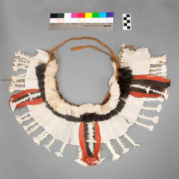 Armband made of cloth and plastic, and decorated with layered and cut feather.