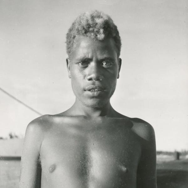 Close-up portait of shirtless man with curly hair