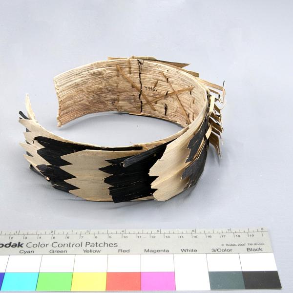 Cuff made of cloth, plastic, and feathers.
