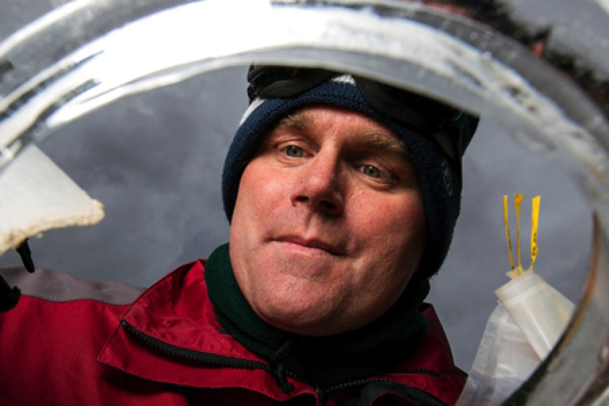 Byron Adams looking through a glass dish