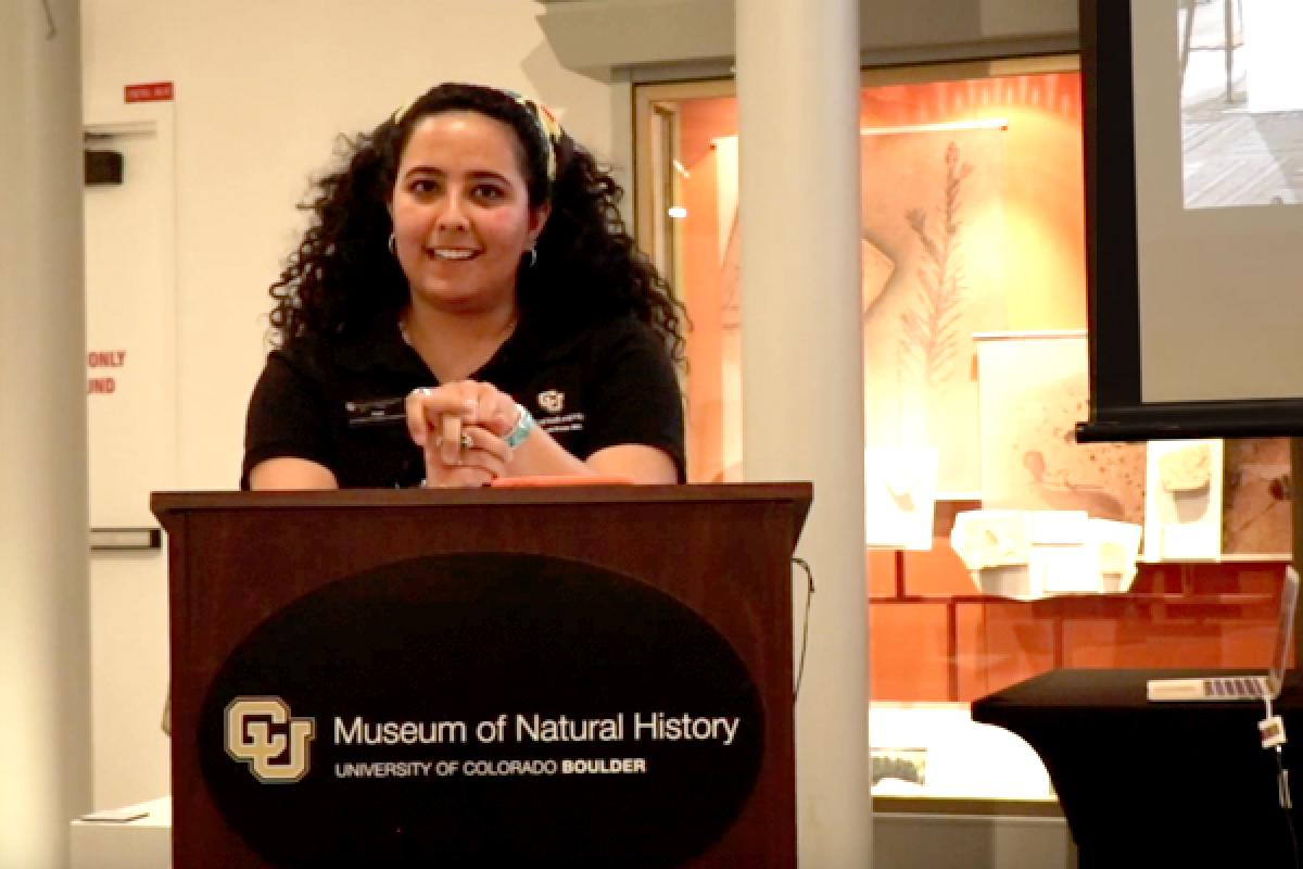 female student at podium speaking