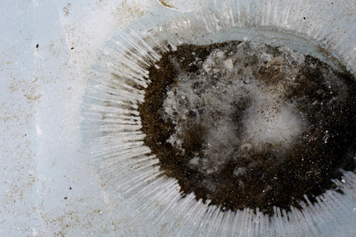 Small hole in ice filled with water