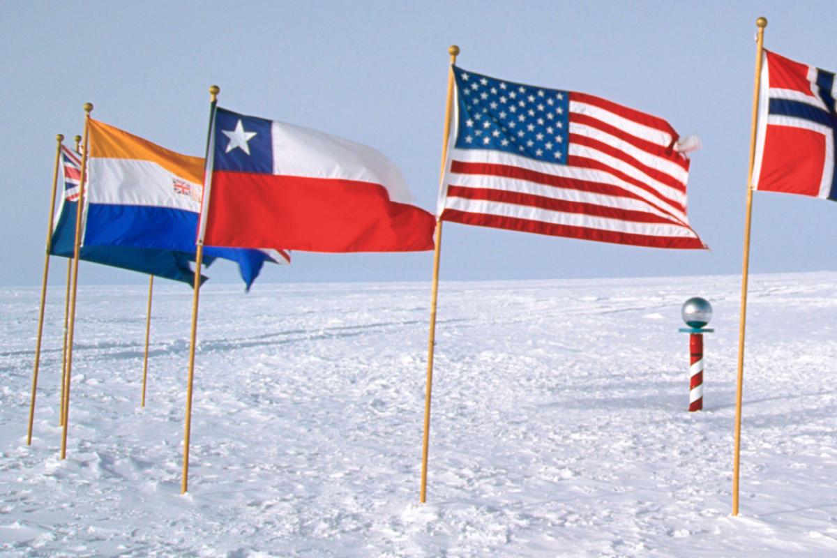 Flags of the world arranged around the South Pole marker