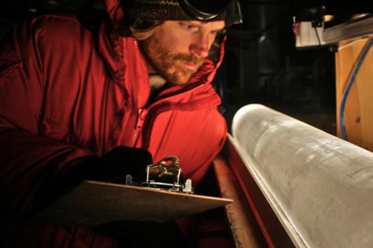 Researcher studying ice core in lab