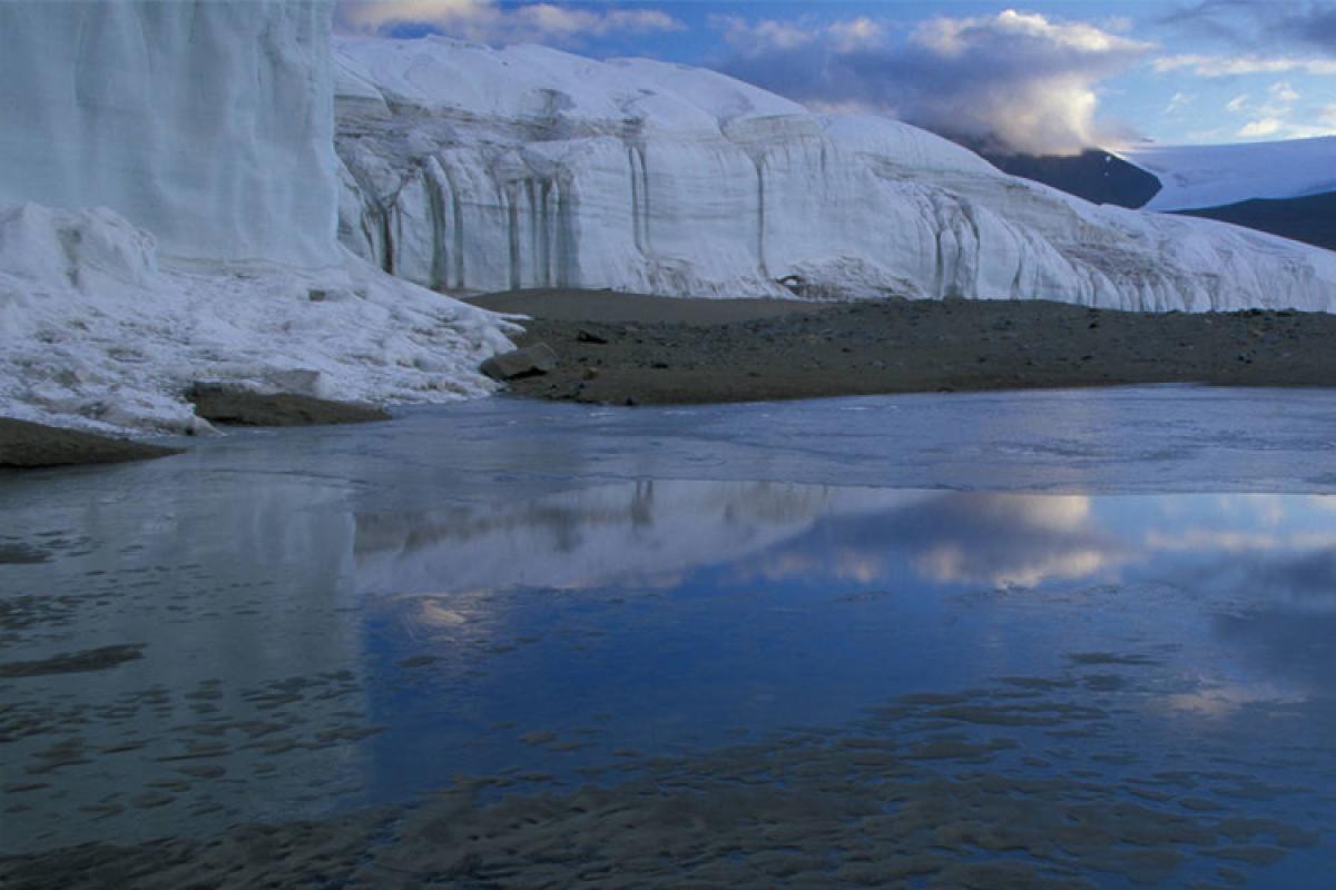 calm lake with glacier in the background