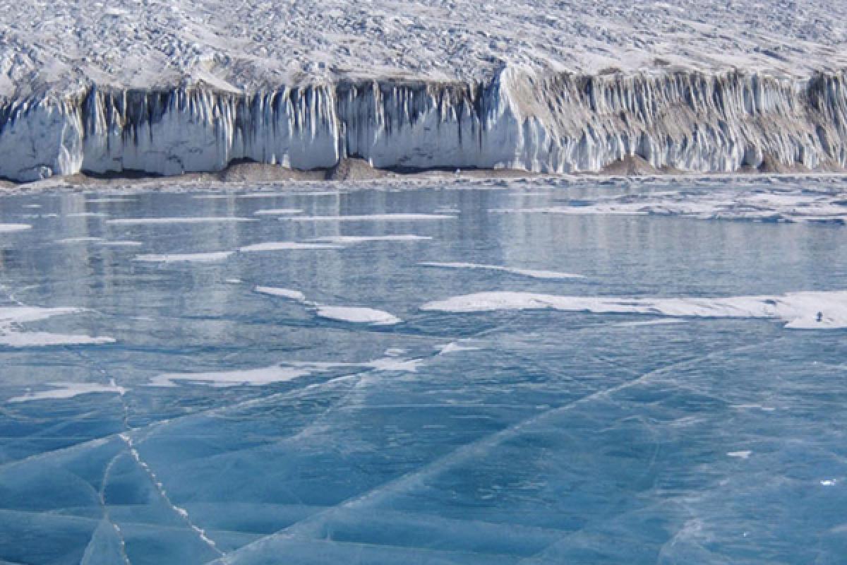 bight blue frozen lake with cracks in ice