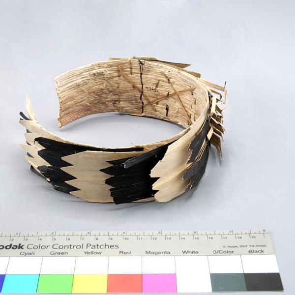 Cuff made of cloth, plastic, and feathers.
