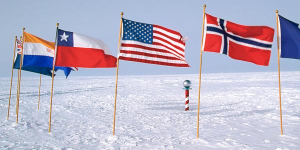 Flags of the world arranged around the South Pole marker