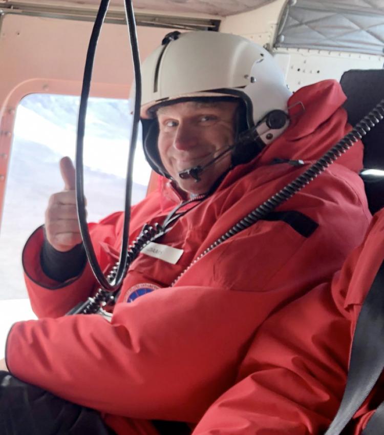 Byron Adams in Helicopter giving thumbs up sign