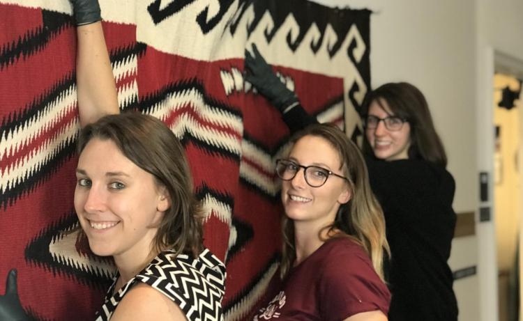 Students hanging textile