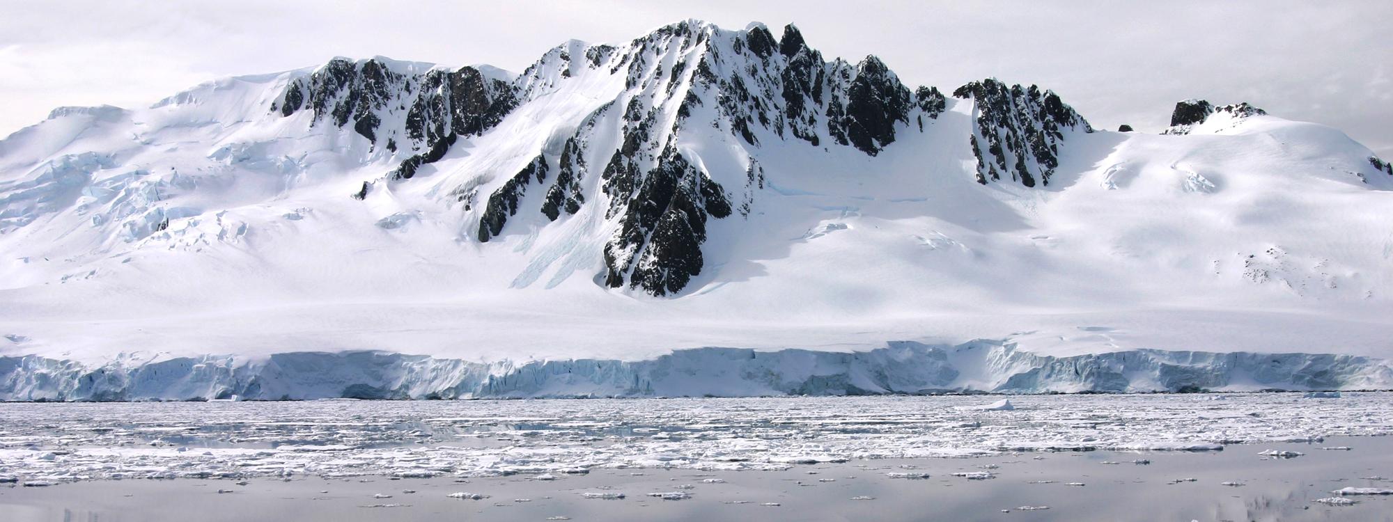 high mountains covered in snow on the antarctic coast