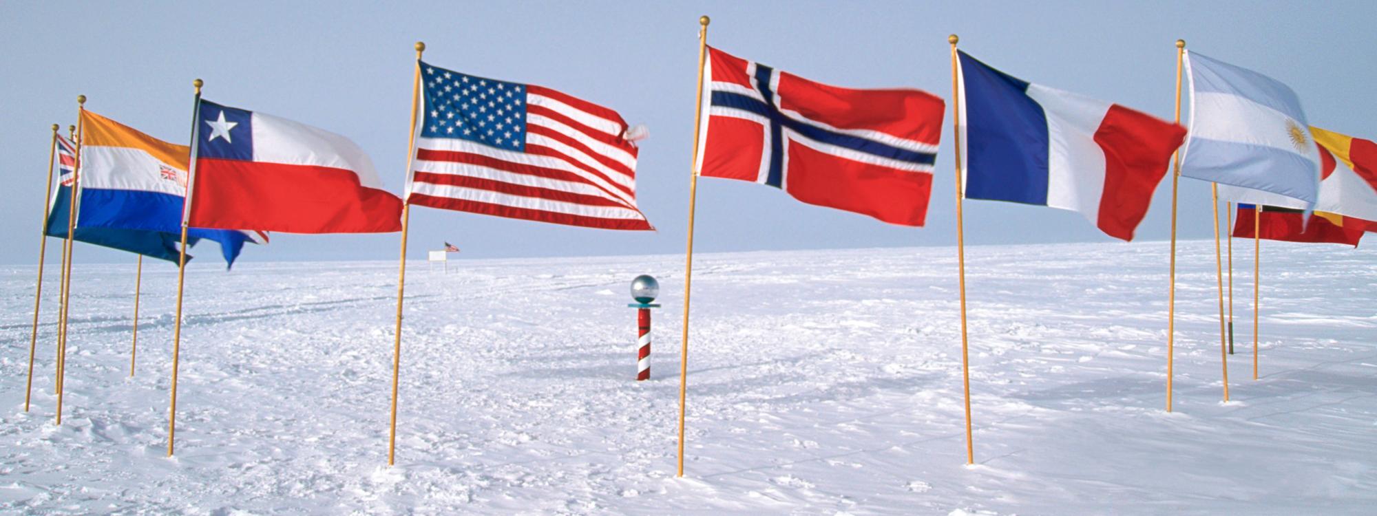 Row of flags of different nationalities around south pole