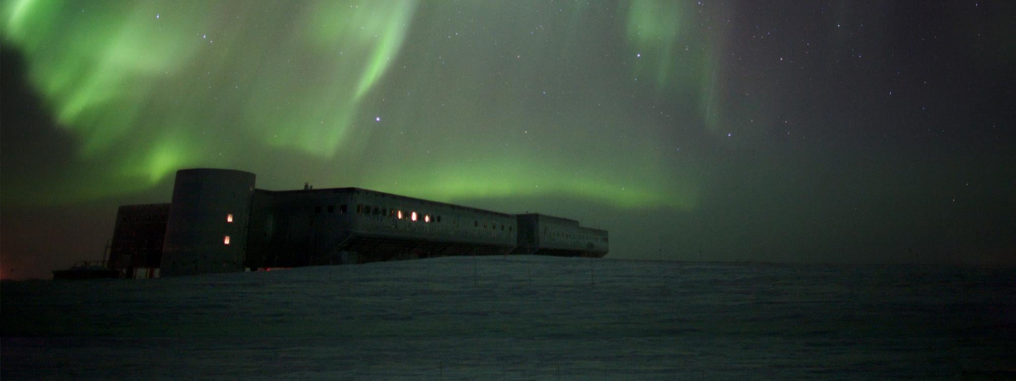 Northern lights over antarctic landscape