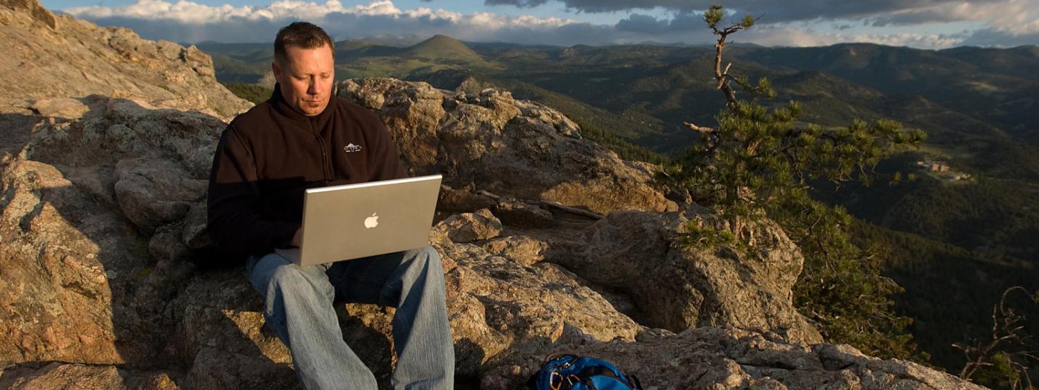 student studying on mountainside