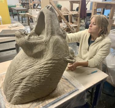 Heather Hillard sculpting bear out of clay