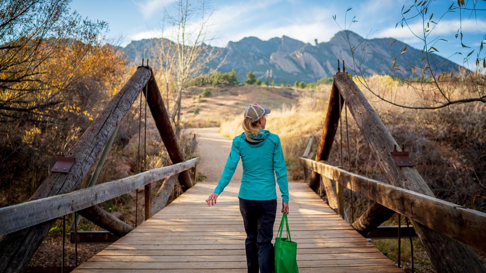 woman walking in front of mountains