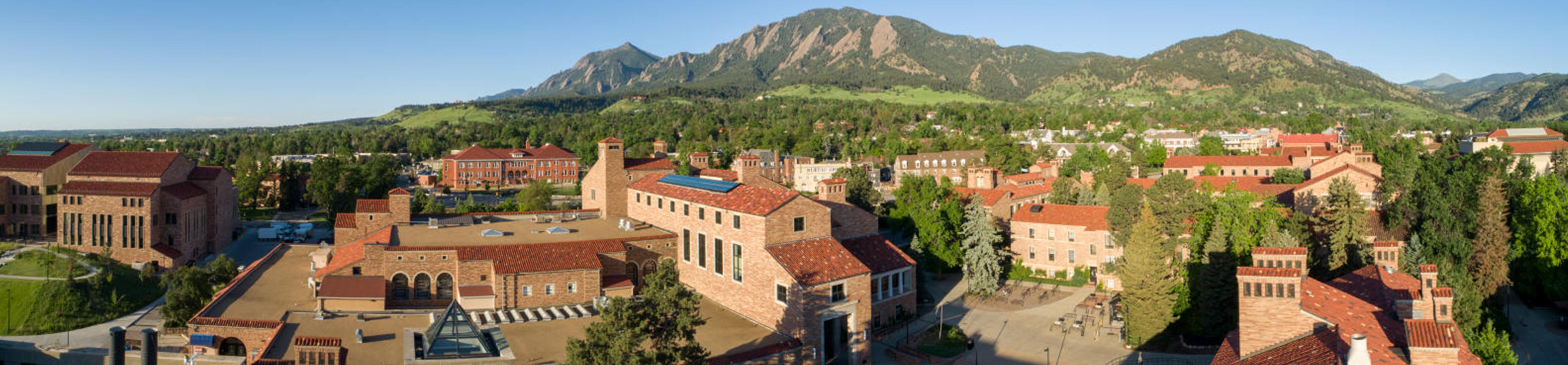 aerial view of campus with flatirons and mountains in the background