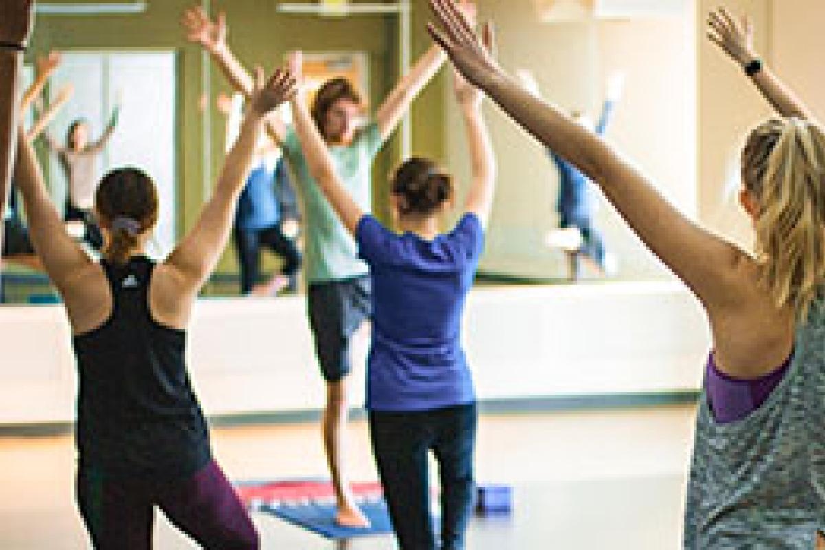 students participating in a group yoga class