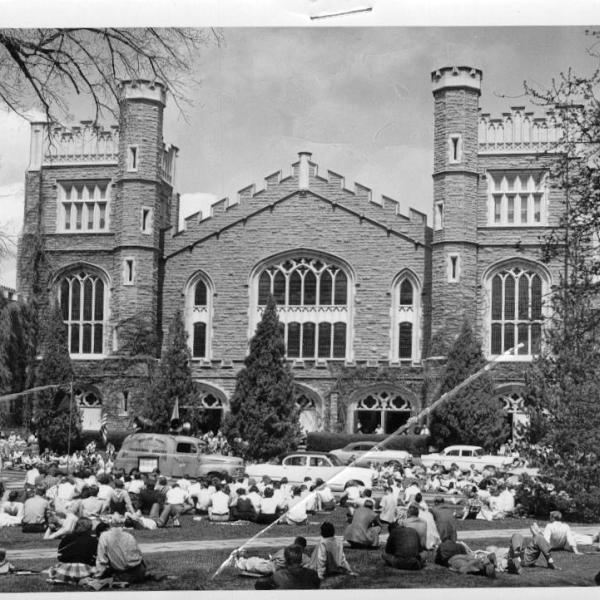 Students listen to an address by Eleanor Roosevelt being broadcasted onto the lawn of Macky Auditorum