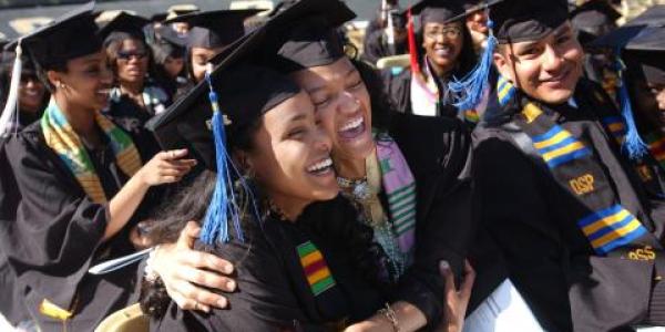 LEAD Alliance students hugging and laughing during their commencement ceremony