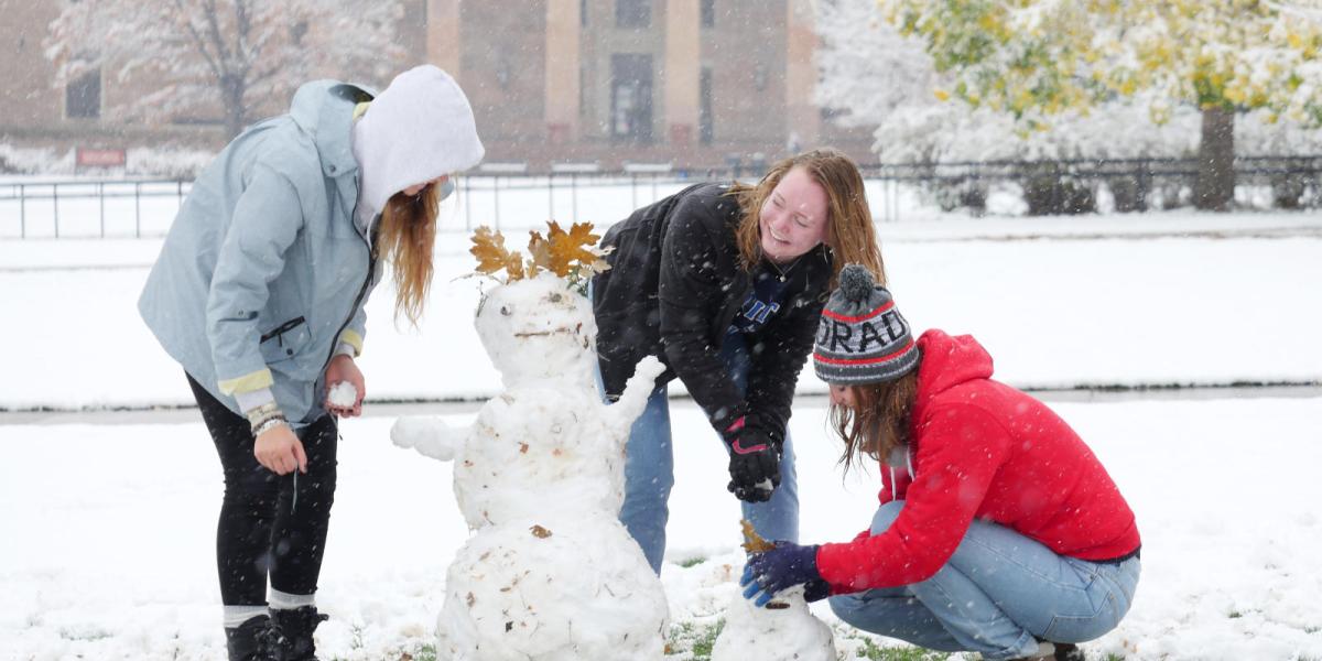 students building a snow person