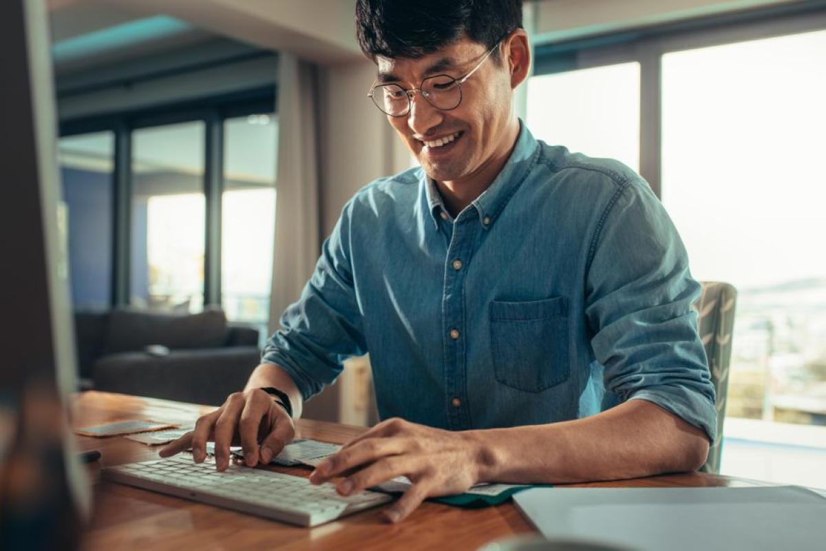 Creative professional sitting at his desk working on desktop computer