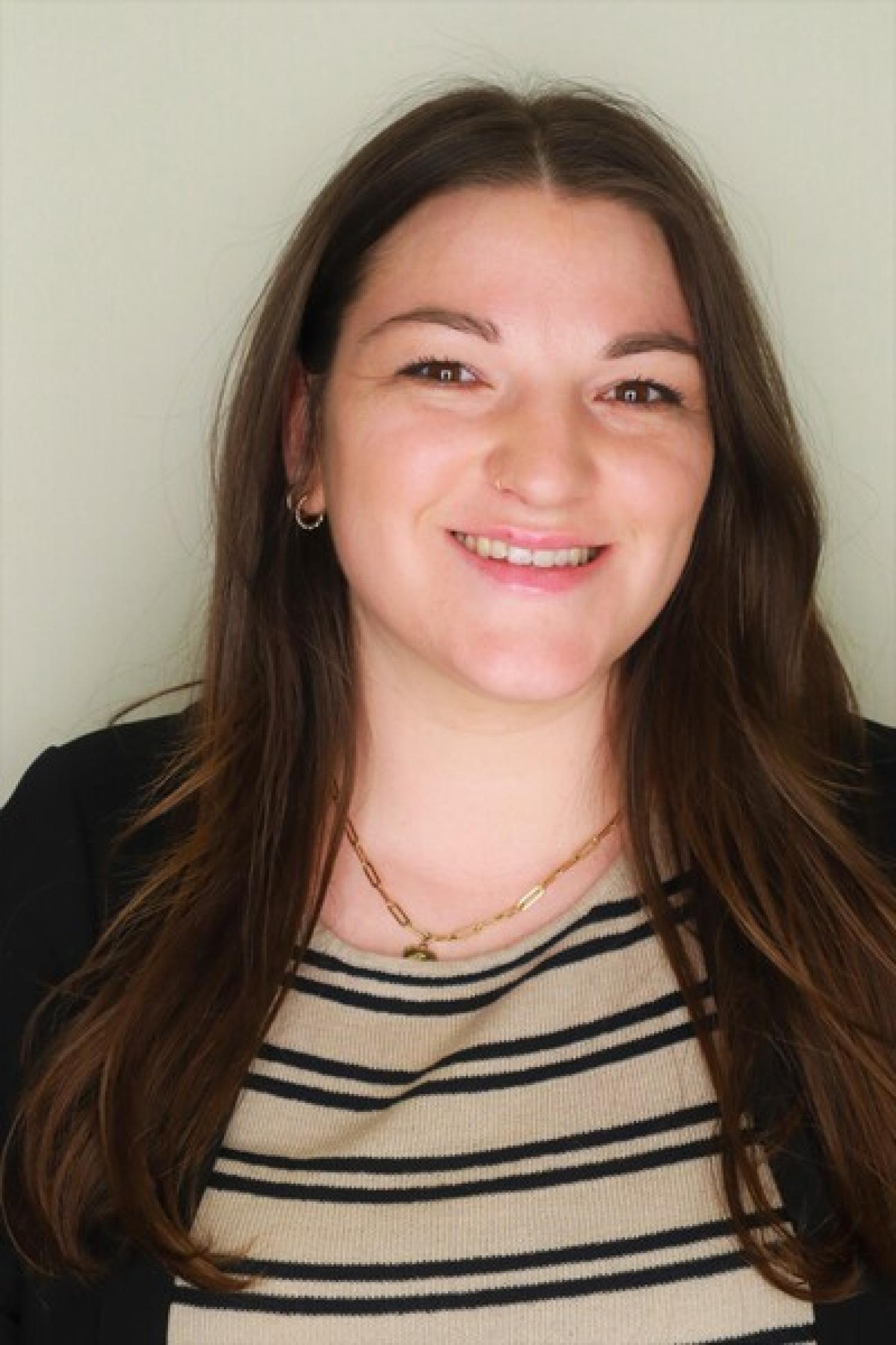 Headshot of Ally Bartley who is a white female with long dark brown hair and brown eyes