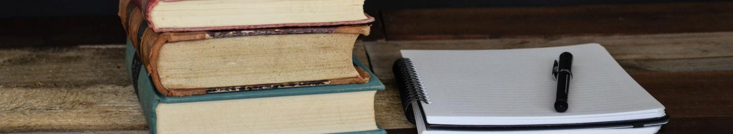 books beside a notebook