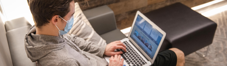 student using his laptop in an office