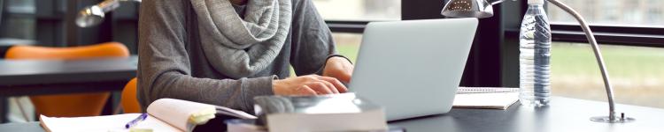 woman taking notes on a computer
