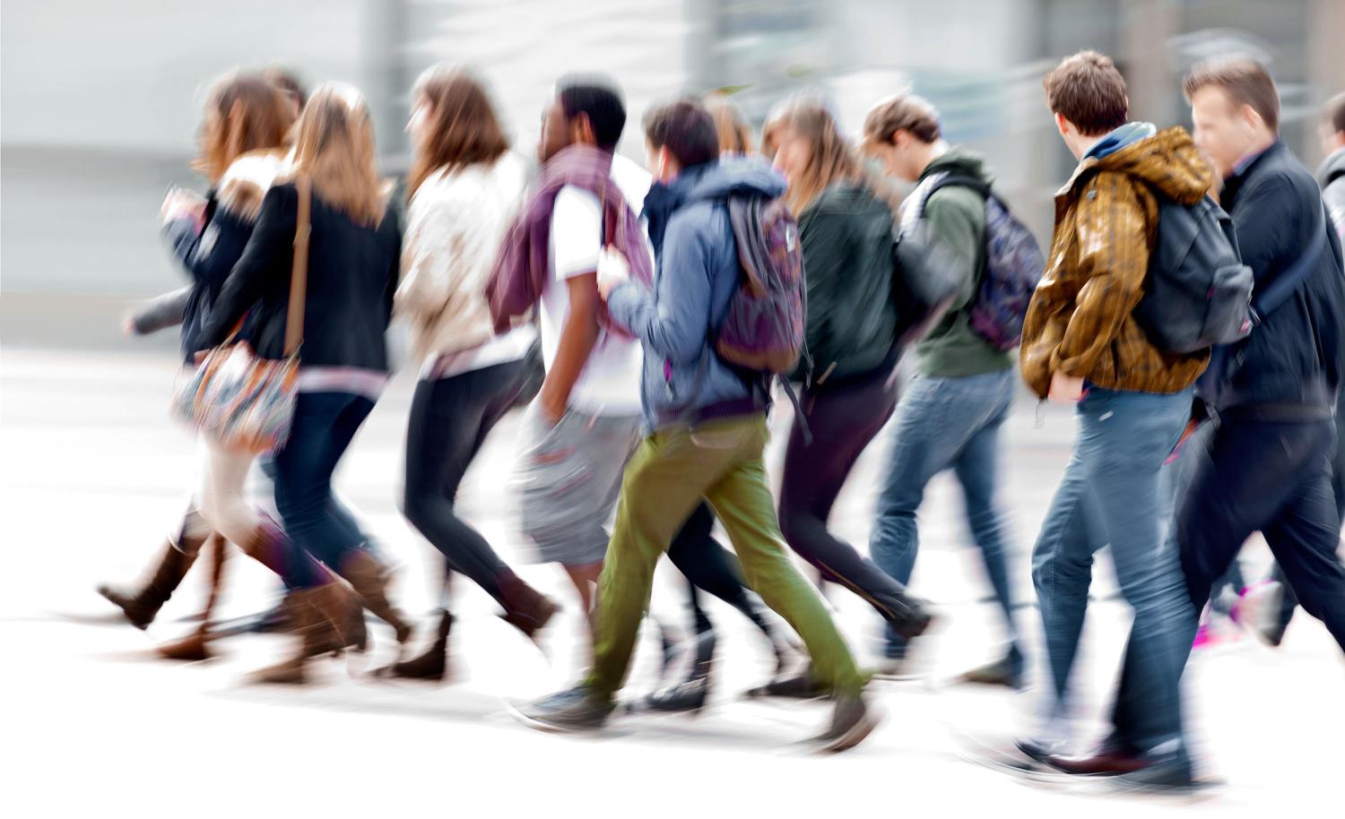 Groups of students walking on street
