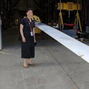 Lucy Pao stands next to the turbine blade at a workshop in Boulder. 