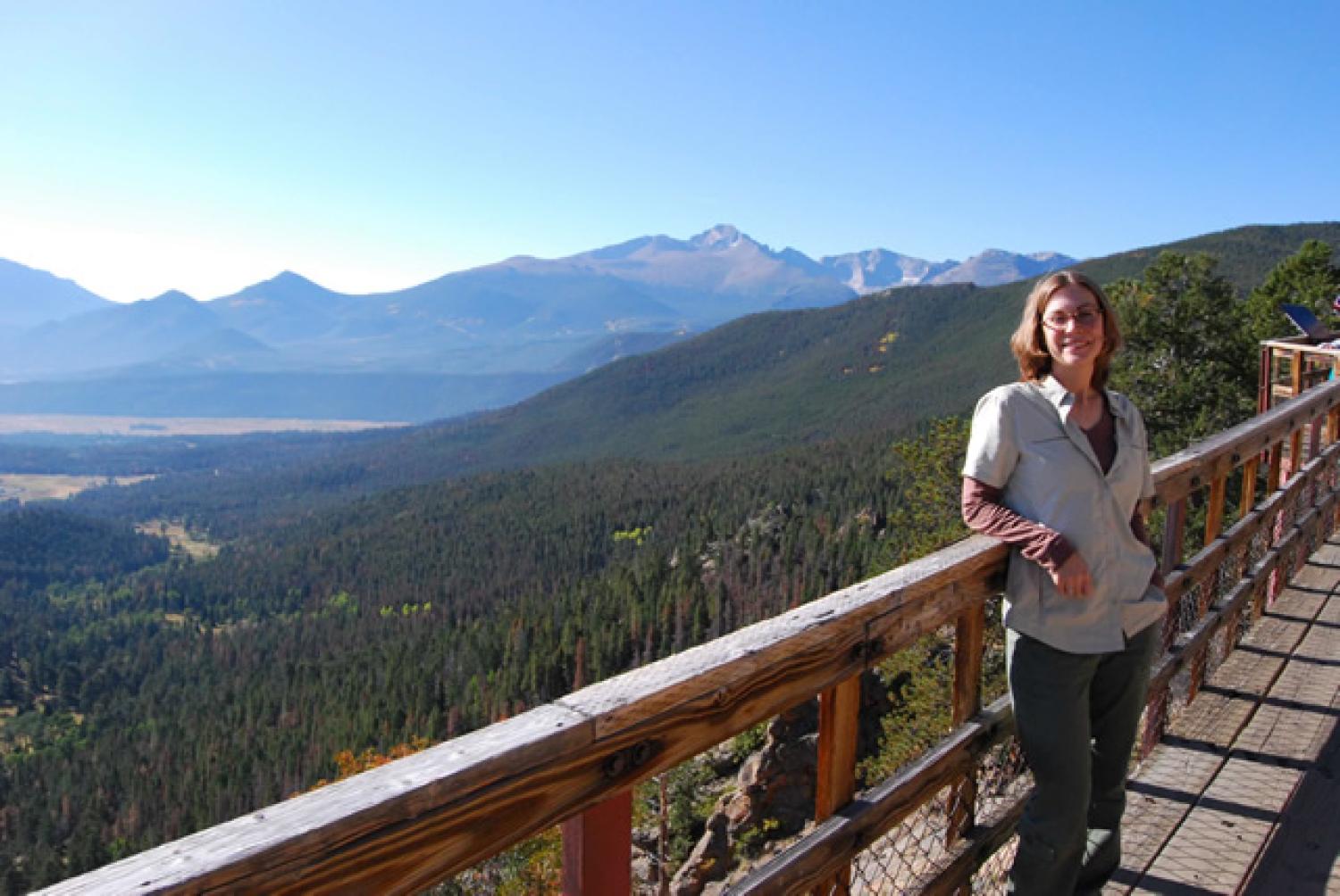 Orlofske standing on bridge overlooking mountain view