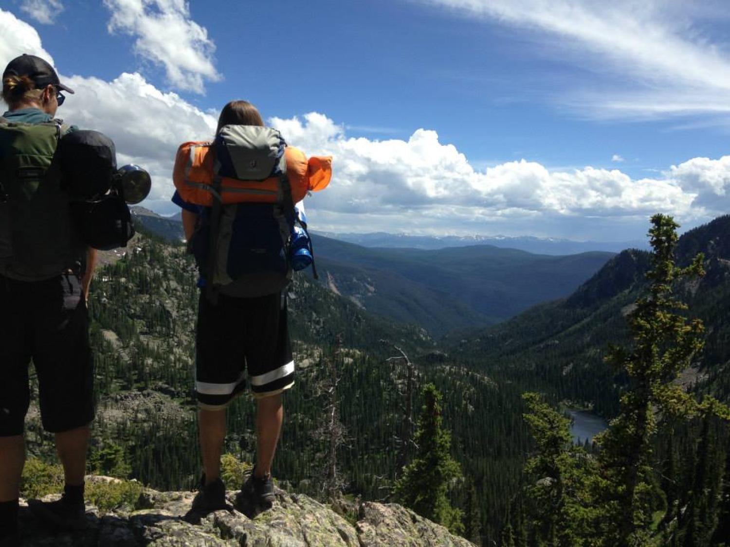 Spencer and a friend looking out over the rocky mountains