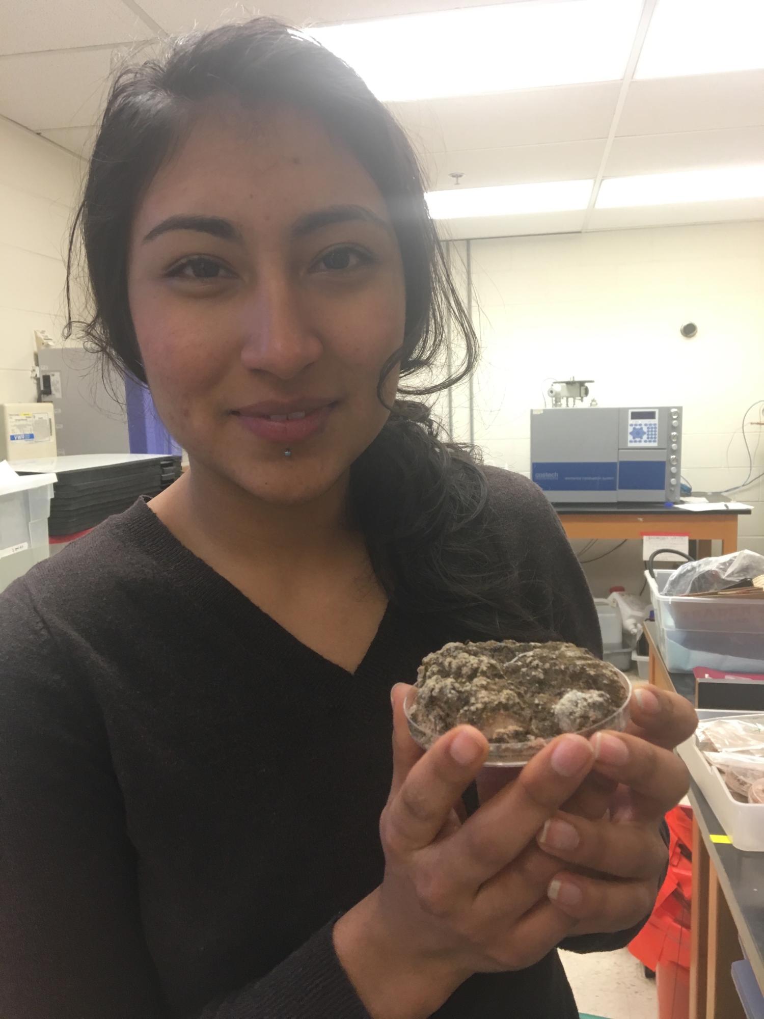 Lopez shows off a sample of biological soil crust.