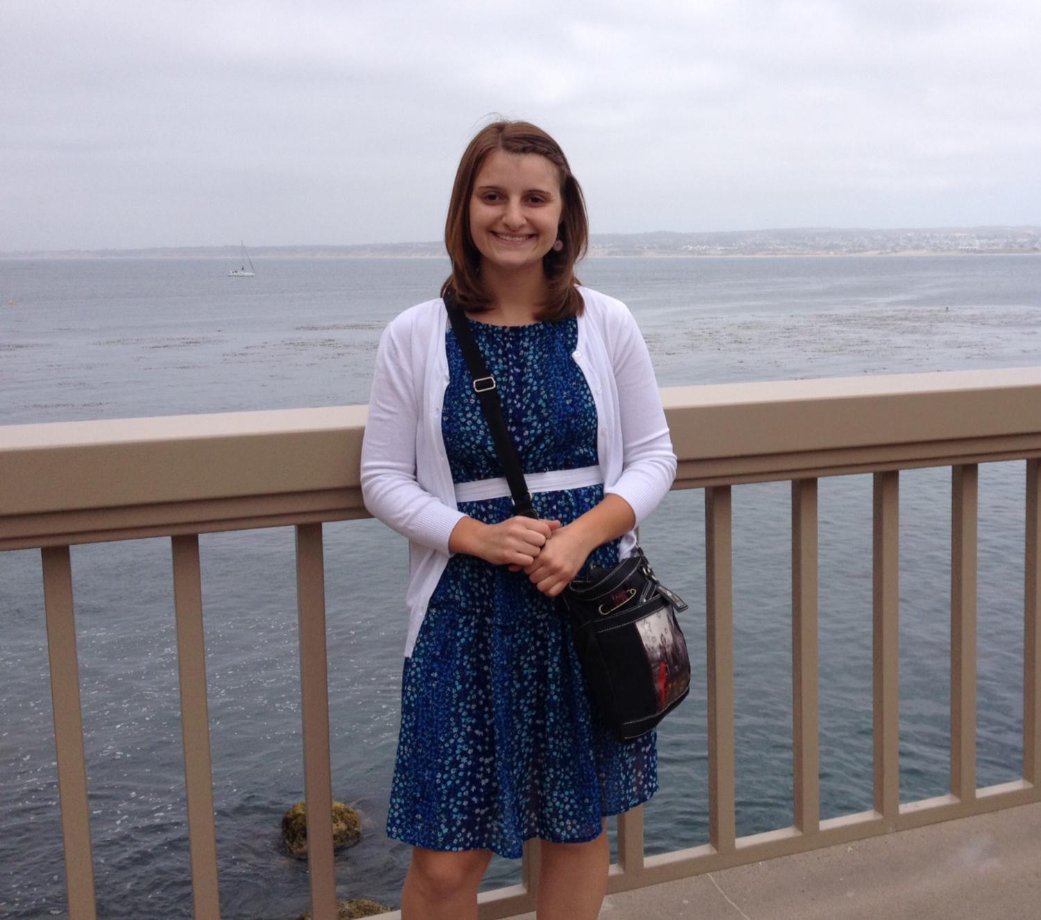 Amedee standing on a pier overlooking the ocean
