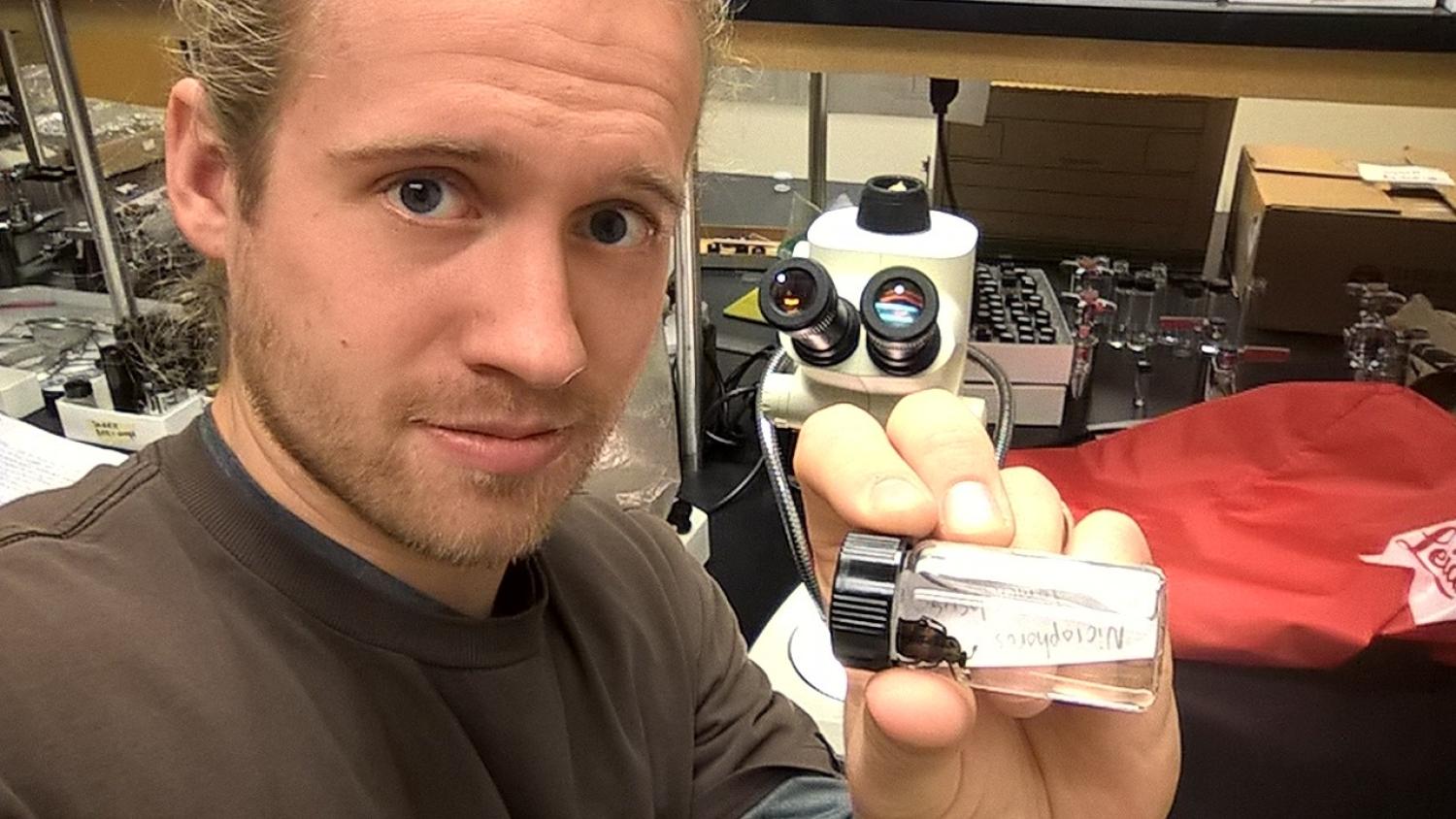 Streb displays a carrion beetle in a bottle.
