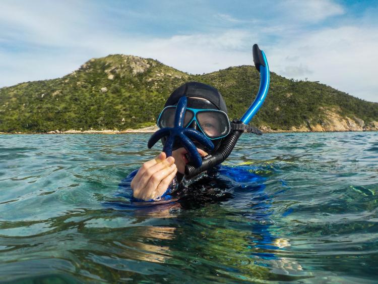 Sankovitz scuba diving with a starfish.