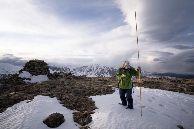 Researcher measuring snow in the alpine