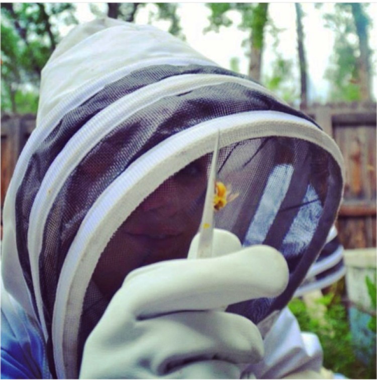 Photo of Rachel Kaspar in a bee suit.