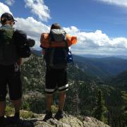 Spencer and a friend looking out over the rocky mountains 