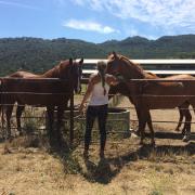 Meg at UROP location with two horses