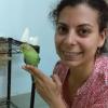 Medina-García poses with a budgerigar at the Wright Behavior Lab.