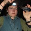 Amanda Hund, examining a barn swallow, captured in a net