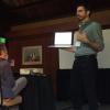 despite a power outage, Scott Taylor presents to a room of ASN members. Scott holds his laptop up for the crowd