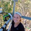 Kayla measuring and sampling plants from an observatory tower