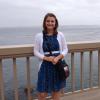 Amedee standing on a pier overlooking the ocean 