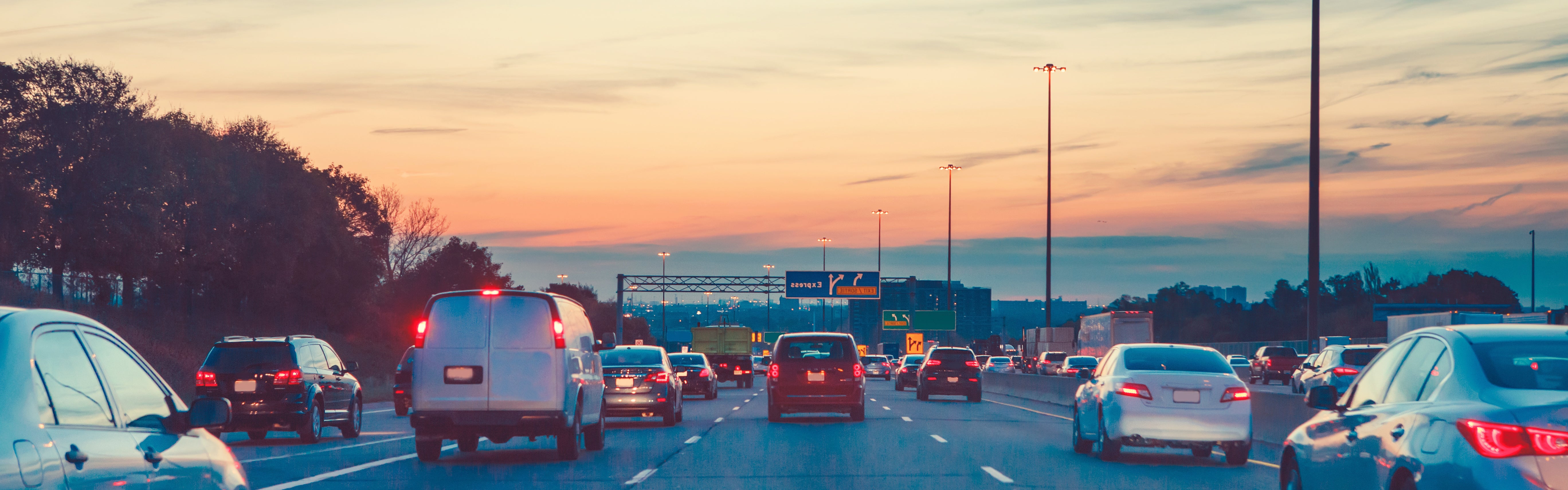 Vehicles on a highway at twilight