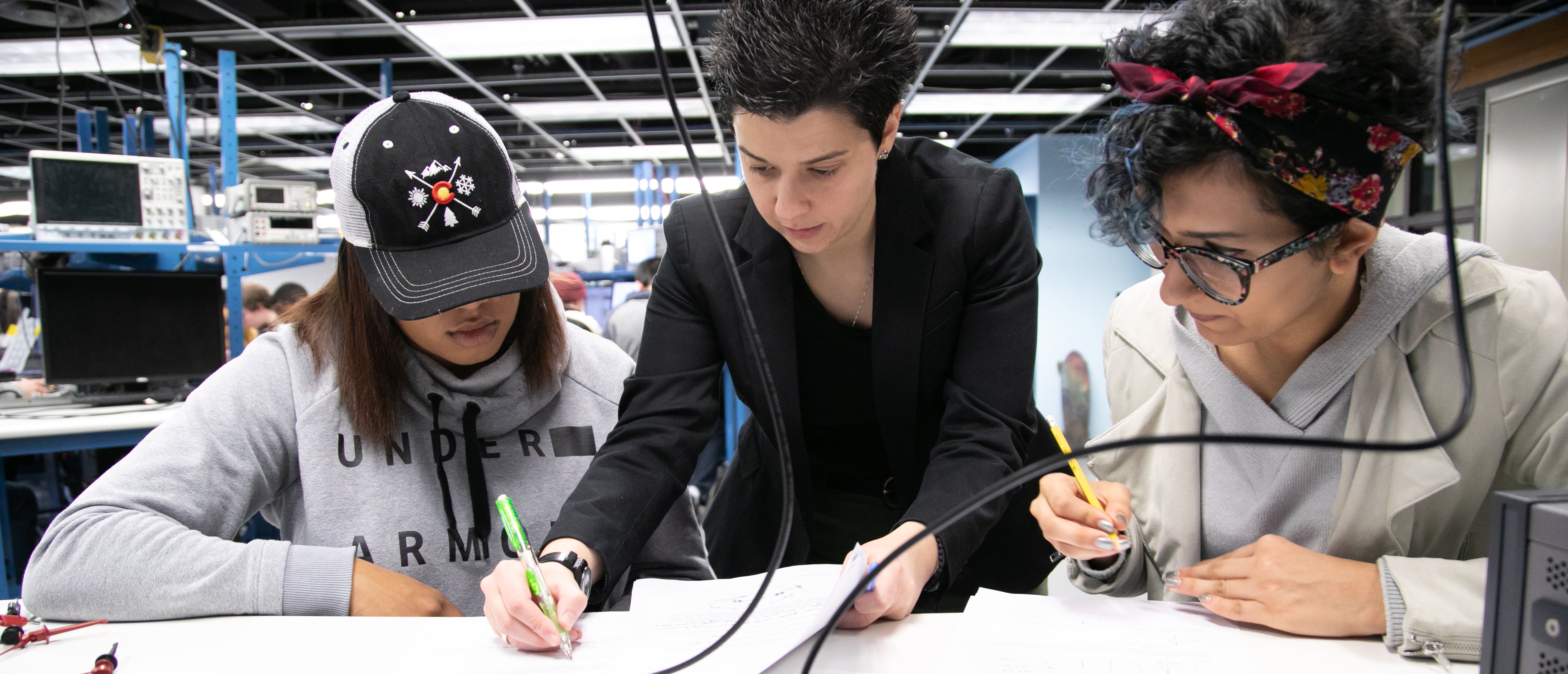 Dimitra Psychogiou works with students in the circuits lab. 