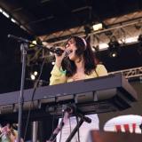 Dafna onstage at a show, behind her keyboard